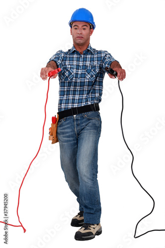Tradesman holding jumper cables