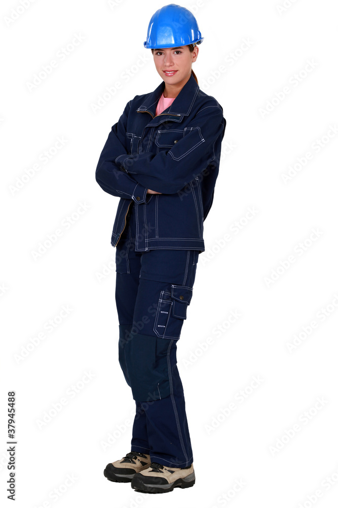 A female construction worker standing in a studio. A female construction worker standing in a studio.