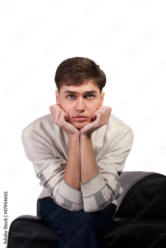 thoughtful young man on the sofa thoughtful young man on the sofa