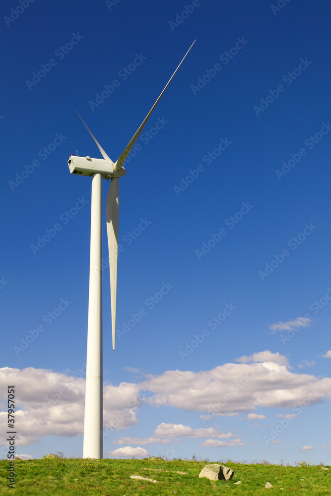 Windmill at the field against blue sky Windmill at the field against blue sky