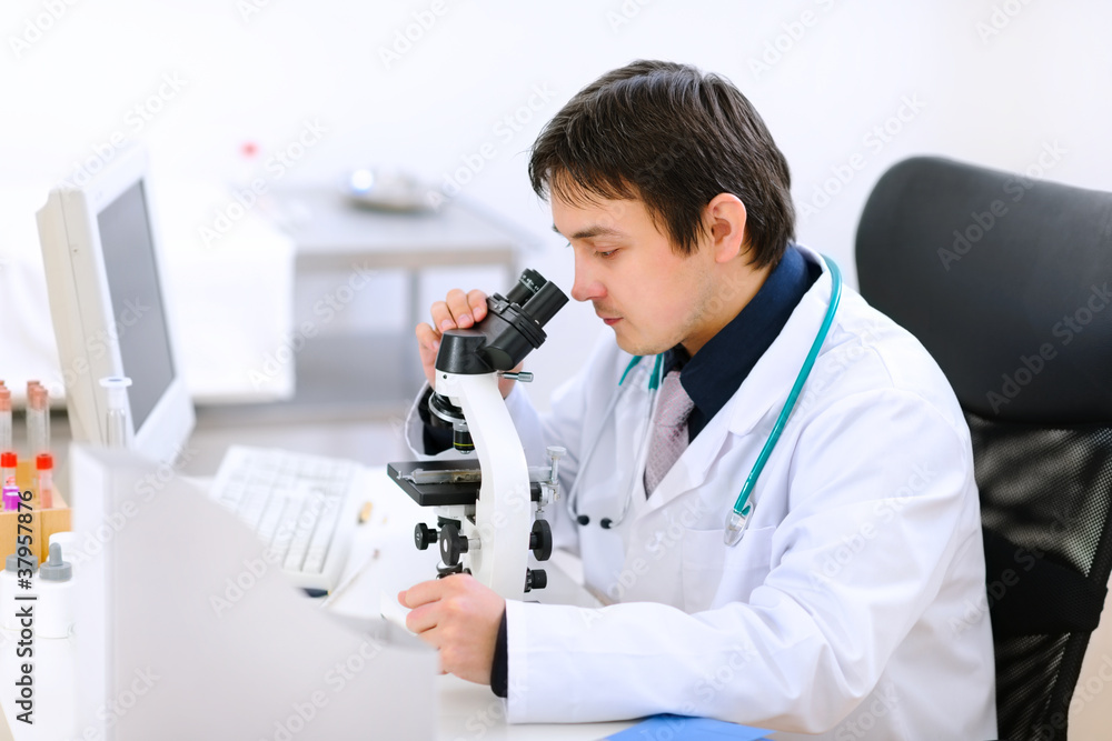 Medical doctor using microscope Medical doctor using microscope