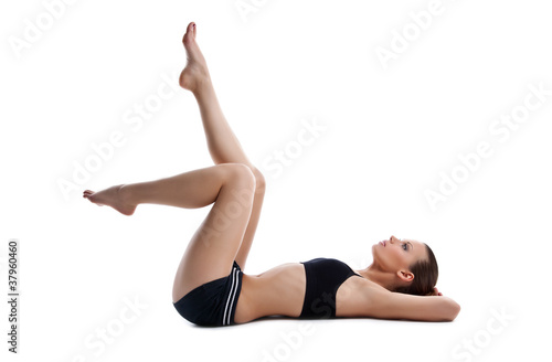 Beauty young woman lay on white in fitness dress