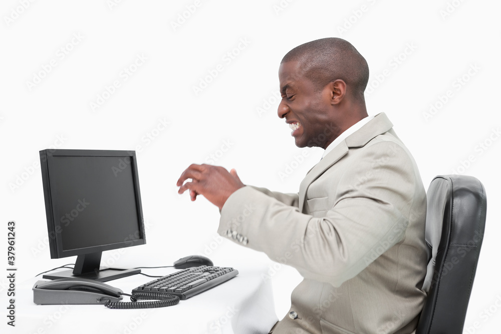 Angry businessman using a monitor Angry businessman using a monitor