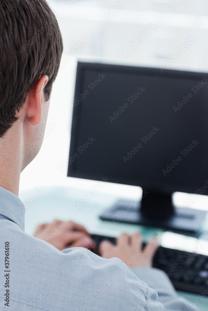 Back view of a businessman using a computer Back view of a businessman using a computer