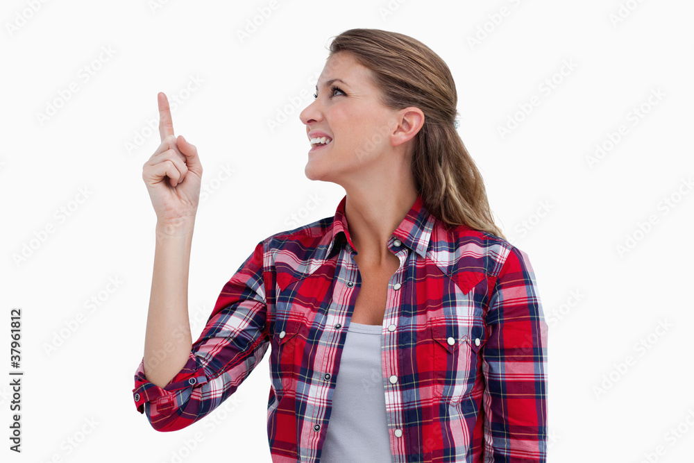 Smiling woman pointing at a copy space Smiling woman pointing at a copy space