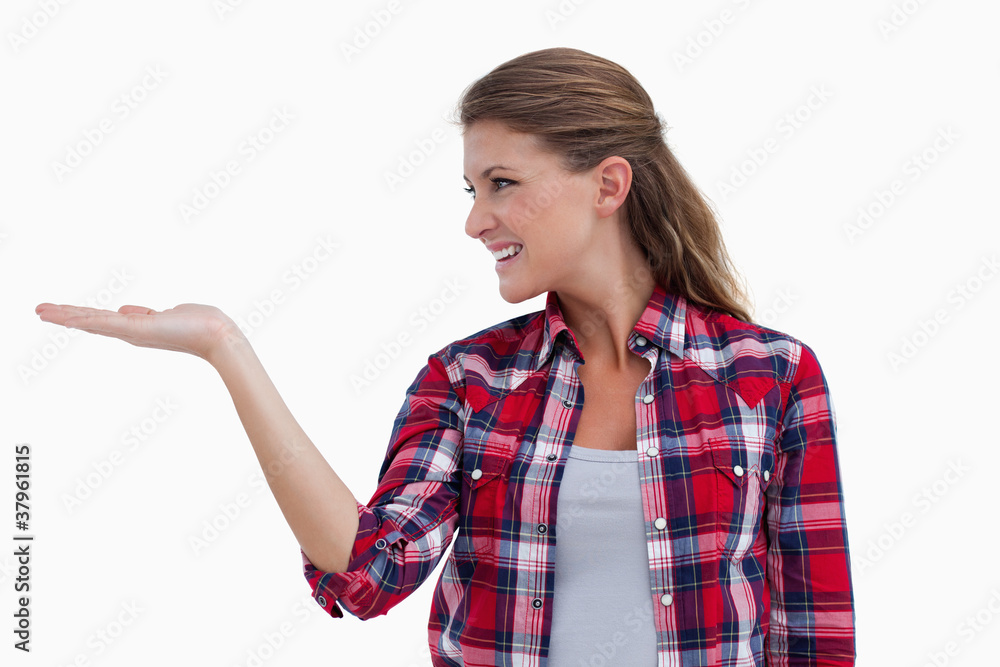 Smiling woman displaying a copy space Smiling woman displaying a copy space
