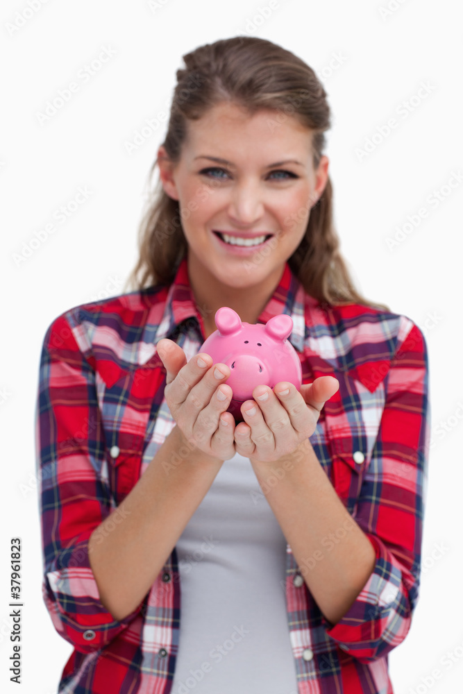 Portrait of a woman holding a piggy bank Portrait of a woman holding a piggy bank
