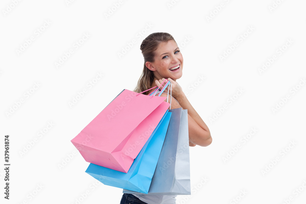 Back view of a cheerful woman holding shopping bags Back view of a cheerful woman holding shopping bags