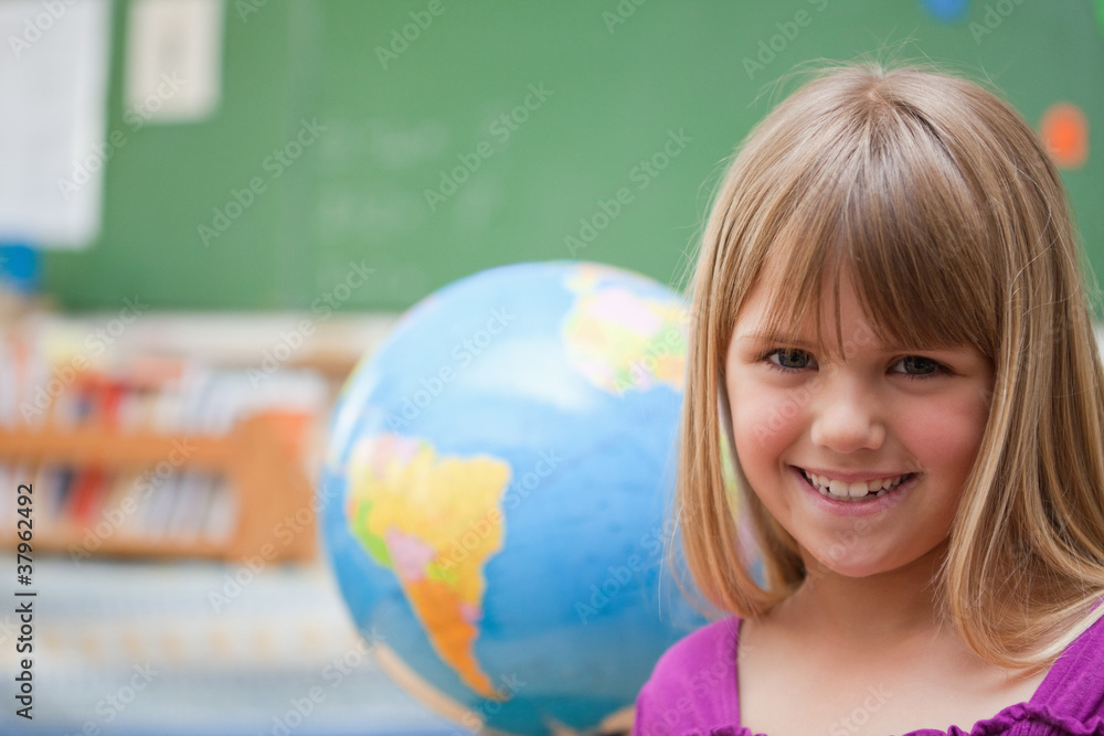 Schoolgirl posing in front of a globe Schoolgirl posing in front of a globe