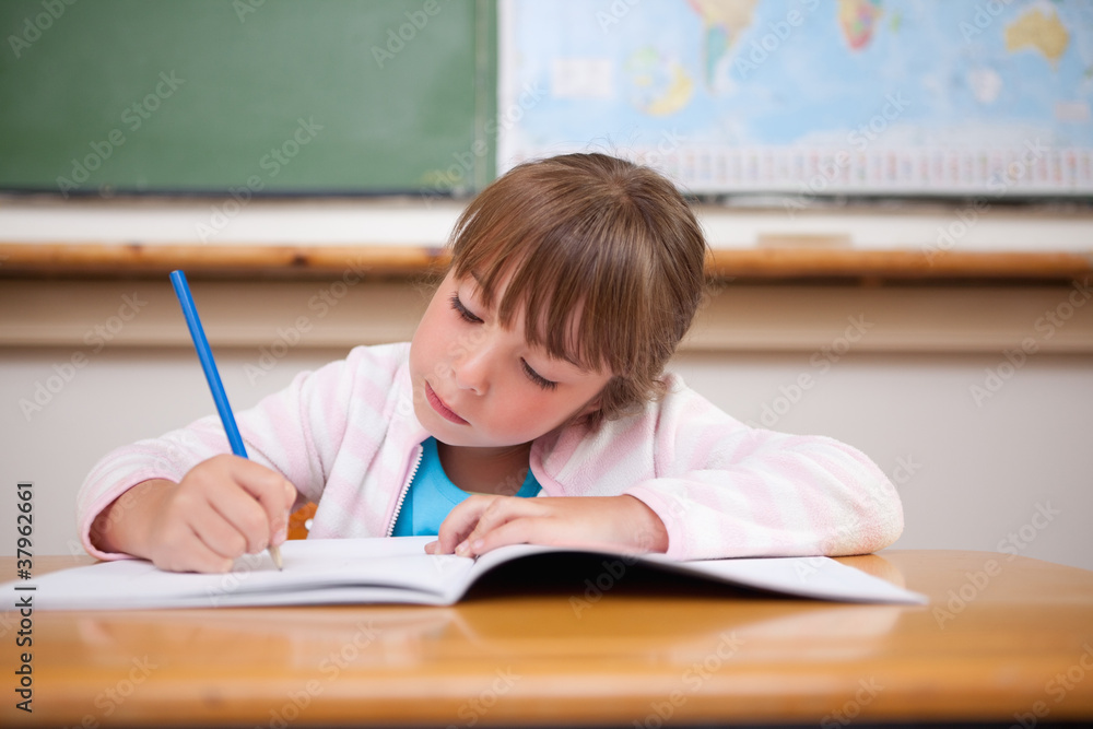 Focused girl writing Focused girl writing