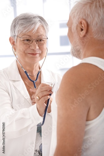 Smiling doctor doing examination