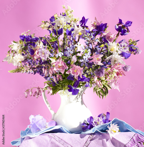 Leinwand Poster bouquet of spring flowers,  iris and aquilegia