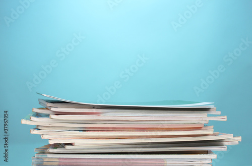 stack of magazines on blue background