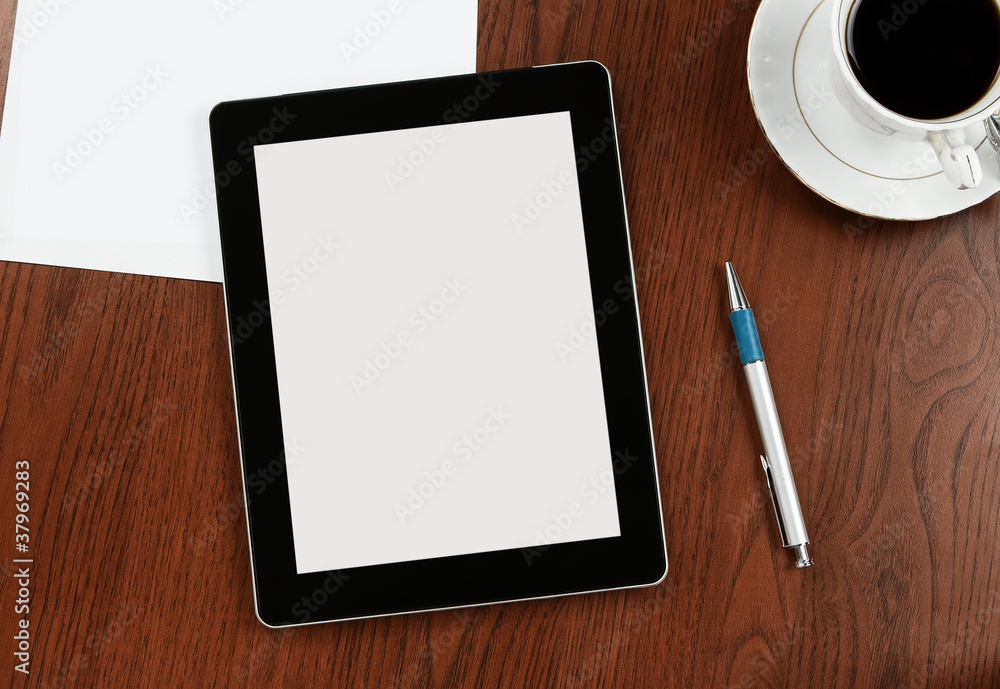 Blank digital tablet on a desk with clipping path for the screen Blank digital tablet on a desk with clipping path for the screen