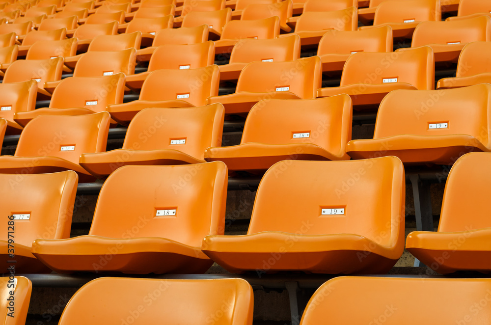 Fototapeta premium Orange Empty plastic seats at stadium
