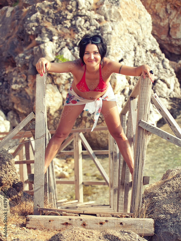 nice girl in bikini near rocks nice girl in bikini near rocks