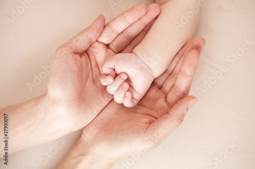 Baby hand in mother's palm