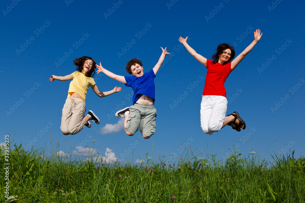 Active family - mother and kids jumping outdoor Active family - mother and kids jumping outdoor