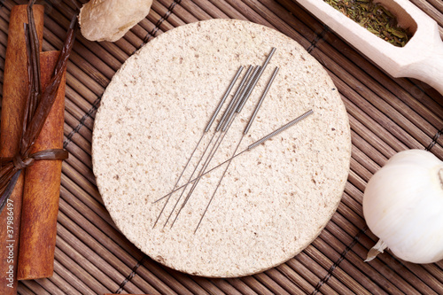 Acupuncture needles and TCM herbs photo