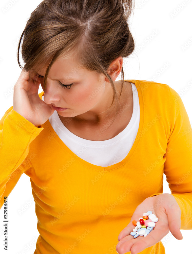 Suffering woman holding pills isolated on white background Suffering woman holding pills isolated on white background