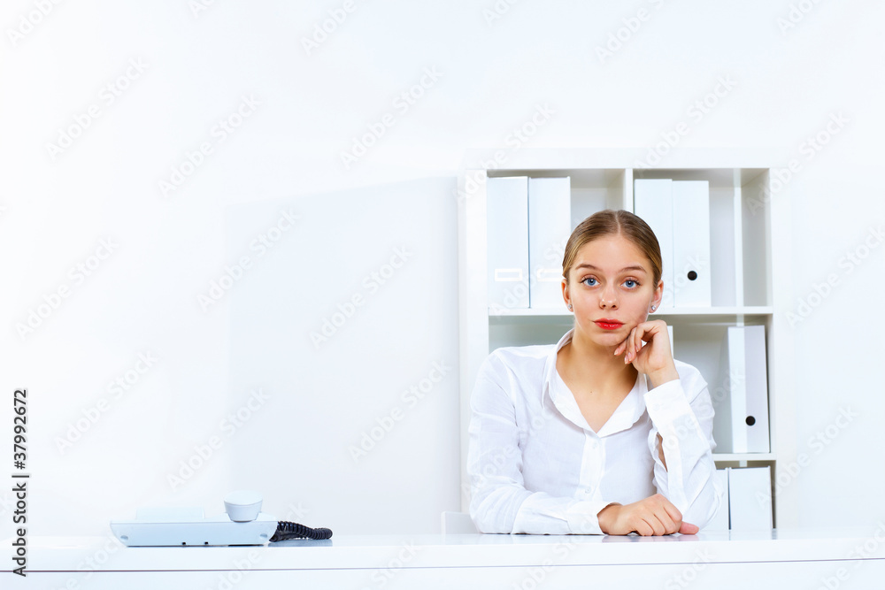 Young woman with a phone in office