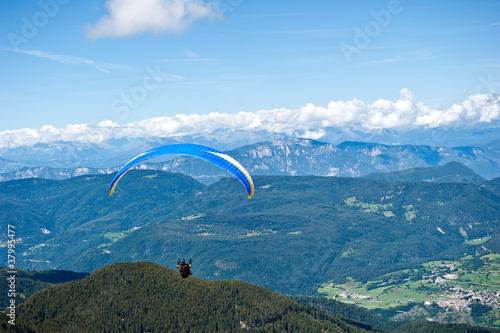 Paraglider flying over the Italian Alps