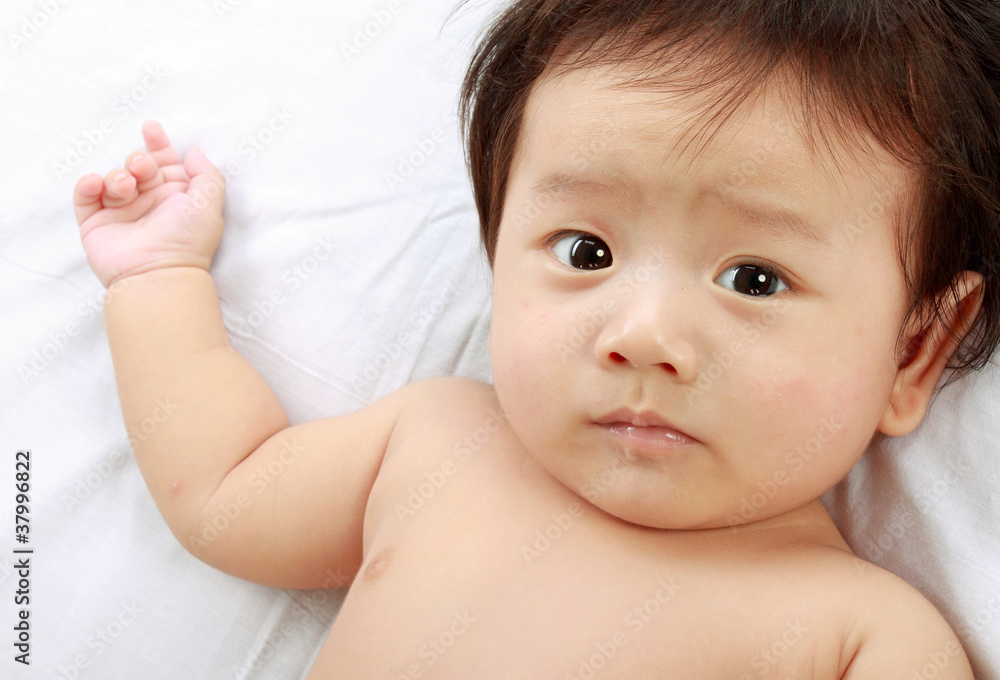baby laying in the bed. baby laying in the bed.