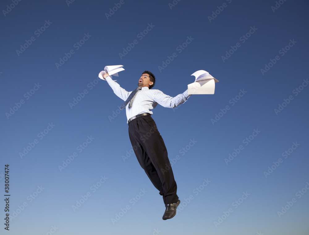 Businessman jump holding documents Businessman jump holding documents