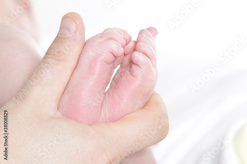 baby s feet in father s hand