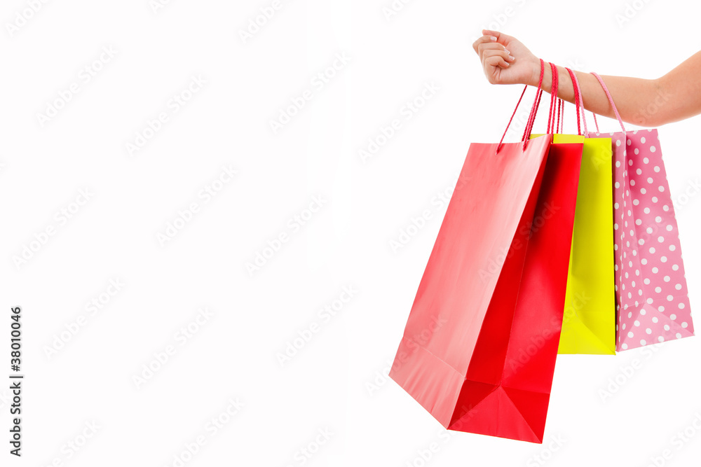 Female hand holding shopping bags, isolated on white