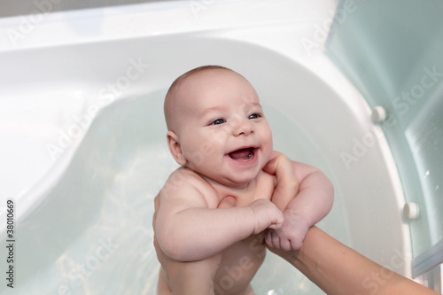 Happy baby taking bath