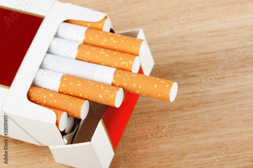 Cigarettes in pack on the breadboard photo