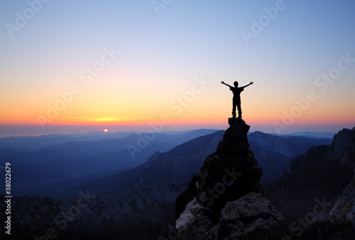 Silhouette of men on top of the mountain