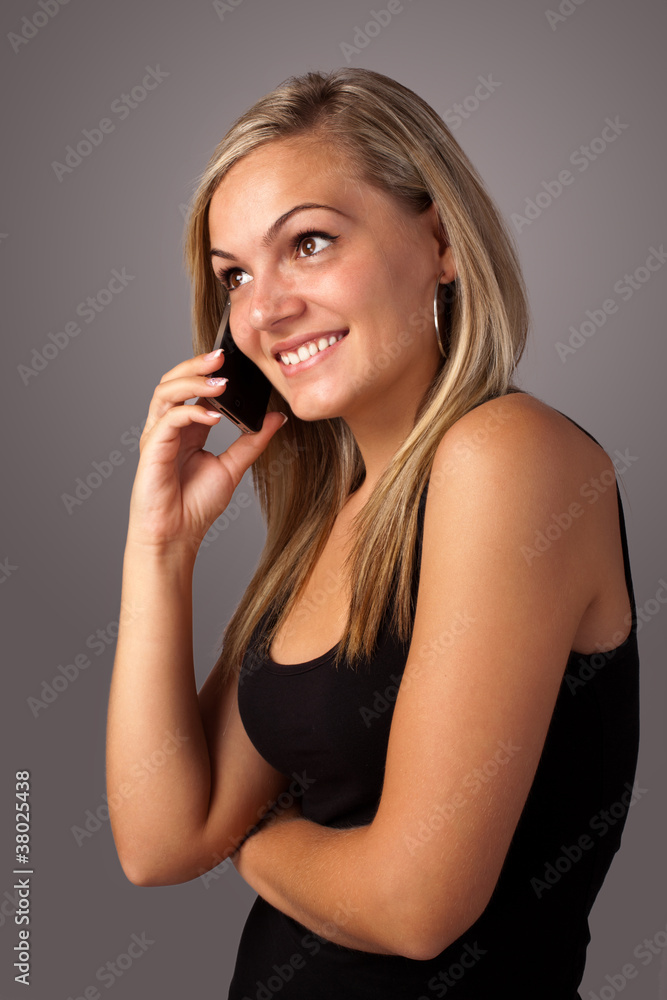 portrait of a cute young woman speaking on the mobile portrait of a cute young woman speaking on the mobile