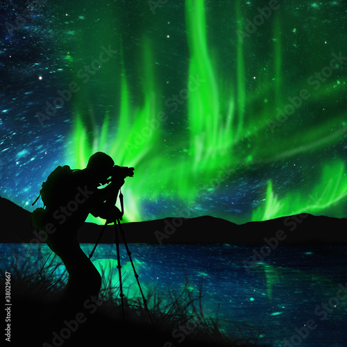 silhouette of photographer shooting stars