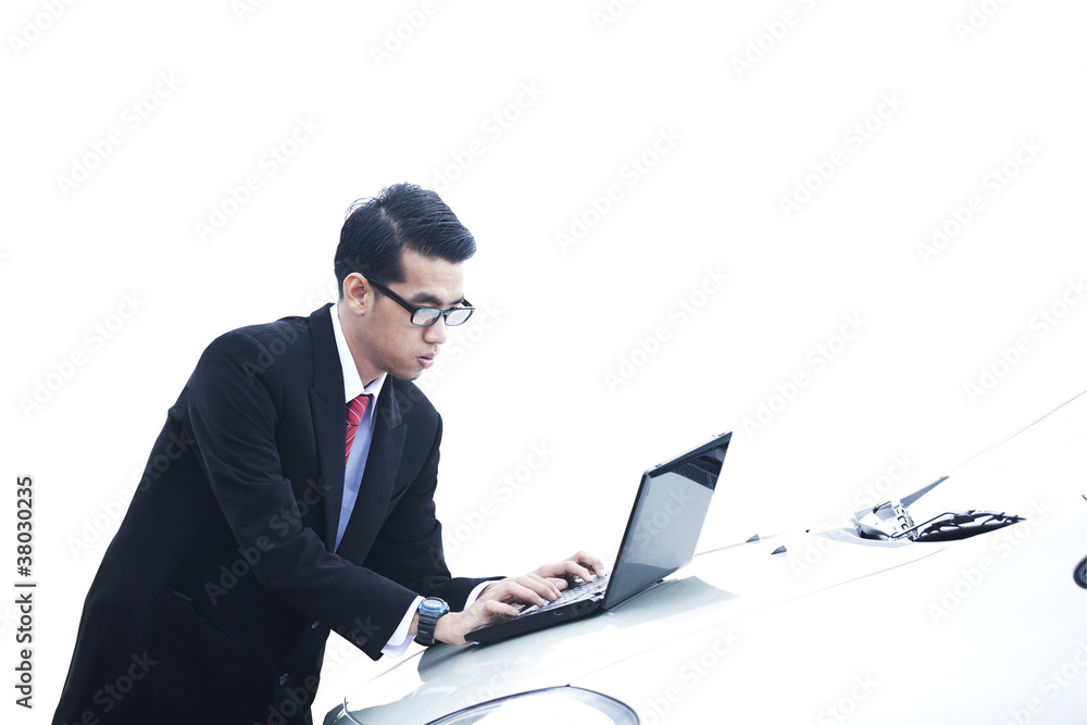 Businessman with laptop on the car Businessman with laptop on the car