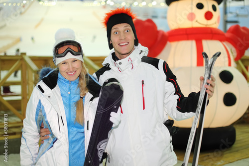 young couple dressed in sports clothes and ski goggles