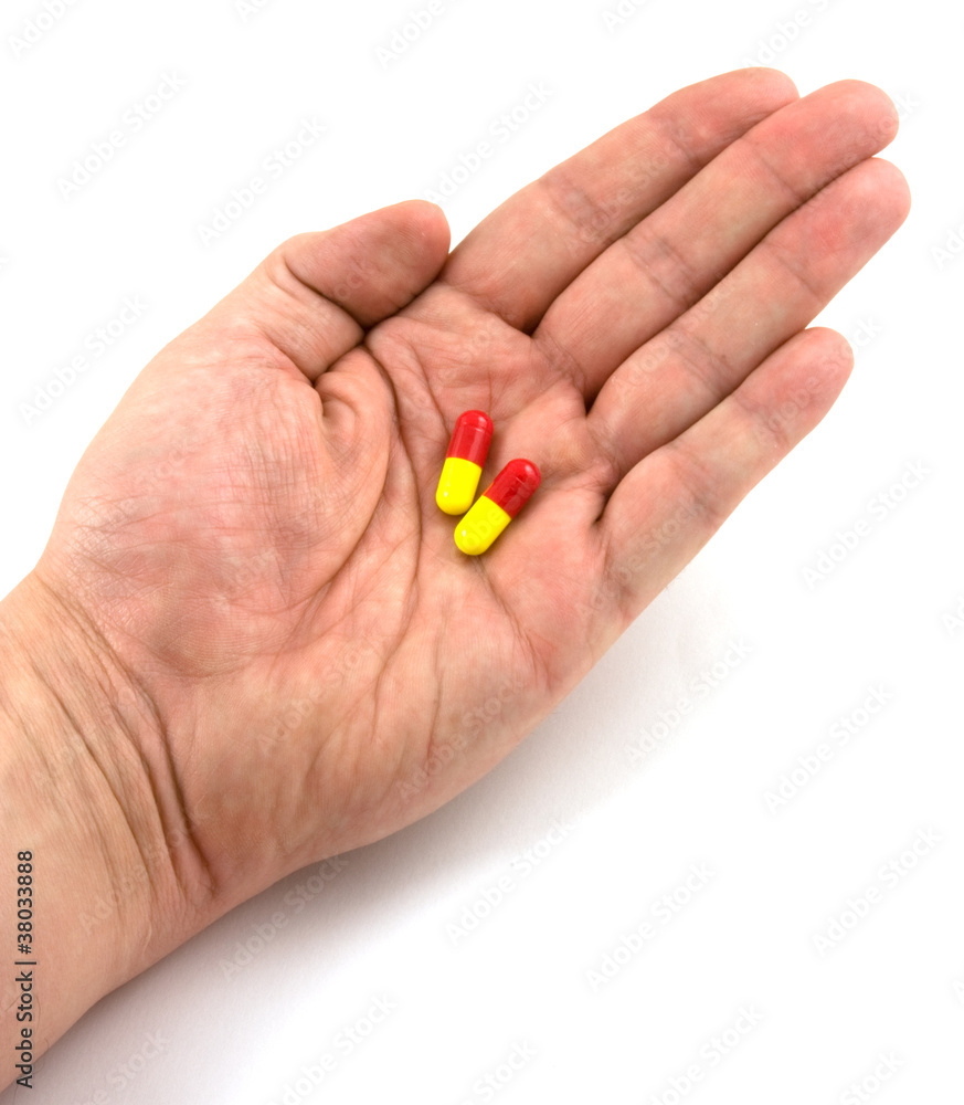 hand holding flu pills hand holding flu pills