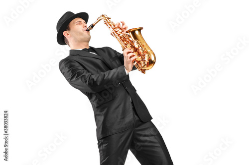 A man in a suit playing on saxophone