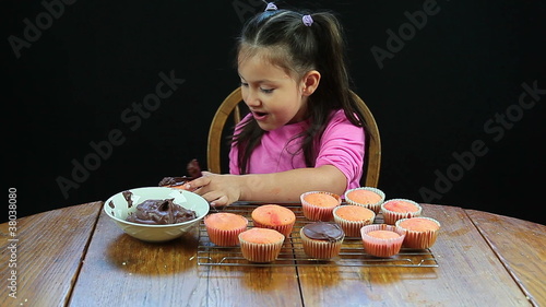 Child making chocolate cupcakes photo