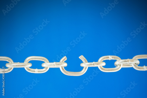 Obraz na płótnie Steel chain with a broken link over blue background w salonie