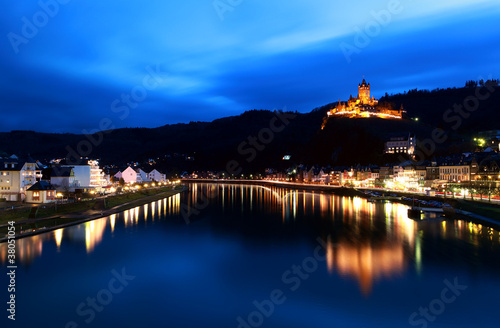 castle reflected in river at night