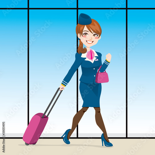 Beautiful stewardess walking at airport terminal