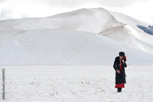 Portrait of beautiful woman in winter landscape.