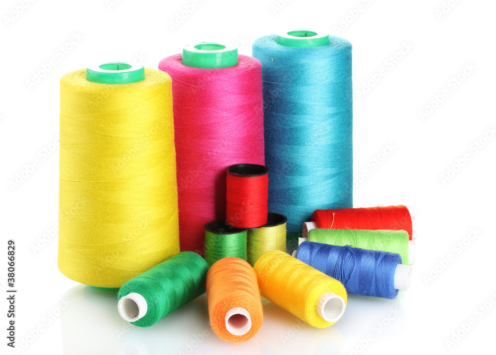 Many-coloured bobbins of thread isolated on white Many-coloured bobbins of thread isolated on white
