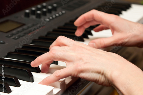 Hands of the musician on a synthesizer