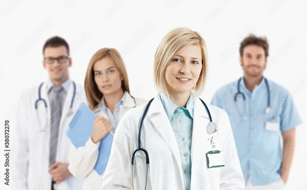 Young medical doctors smiling at camera Young medical doctors smiling at camera