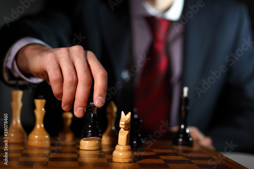 Businessman playing chess