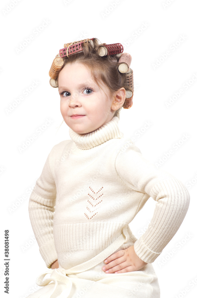 Beautiful little girl with curlers on her head. Beautiful little girl with curlers on her head.