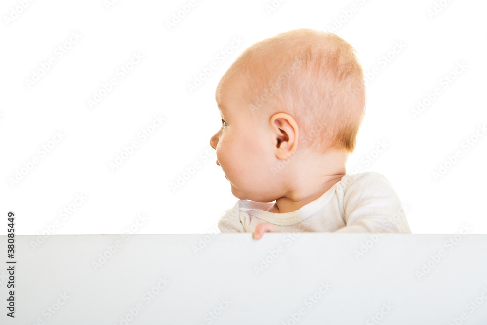 Isolated beaufiful caucasian infant baby behind whiteboard Isolated beaufiful caucasian infant baby behind whiteboard